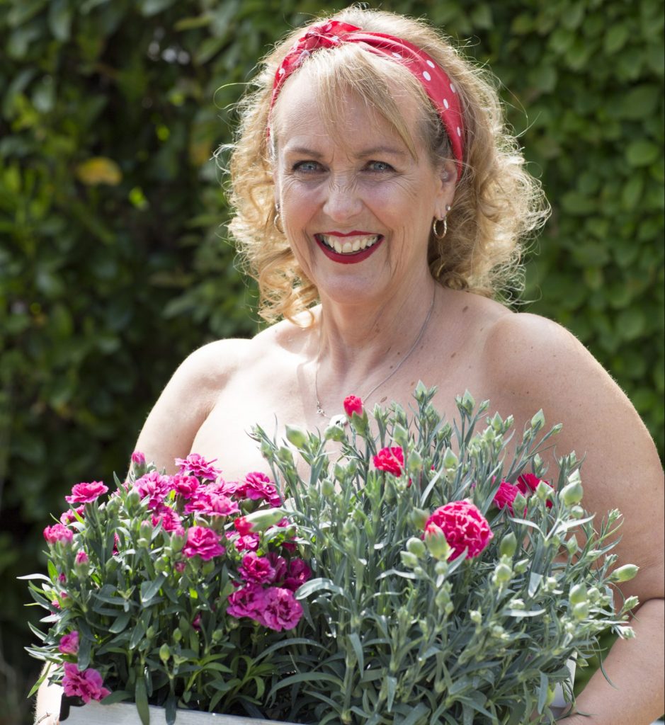 Jo during our calendar shoot, posing with flowers.
